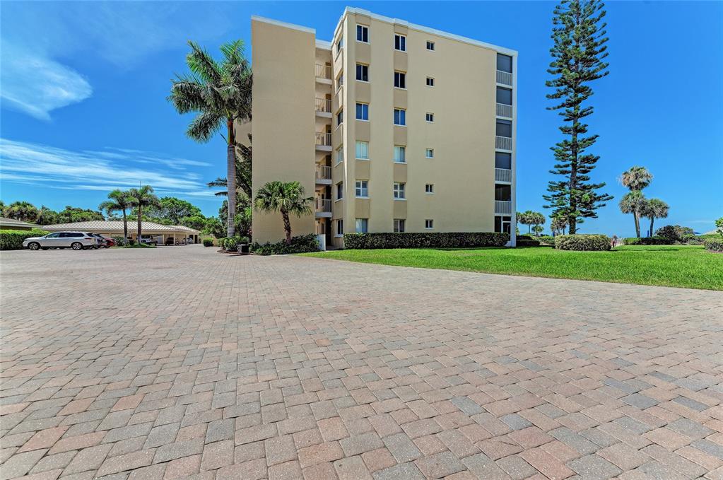 4825 Gulf Of Mexico Drive, Unit 201 Longboat Key, FL 34228 - Photo 23 of 42 a view of a tall building with a yard