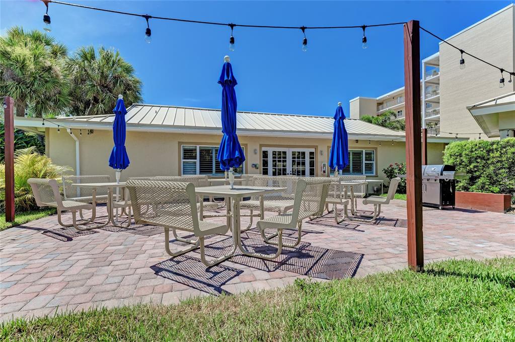 4825 Gulf Of Mexico Drive, Unit 201 Longboat Key, FL 34228 - Photo 33 of 42 a view of a backyard with sitting area