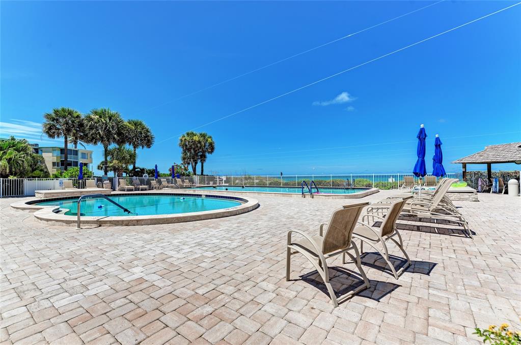 4825 Gulf Of Mexico Drive, Unit 201 Longboat Key, FL 34228 - Photo 37 of 42 a view of a swimming pool with chairs