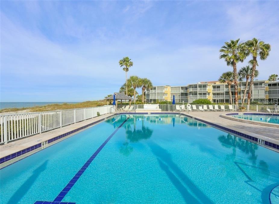 4825 Gulf Of Mexico Drive, Unit 201 Longboat Key, FL 34228 - Photo 41 of 42 a view of a swimming pool with an outdoor seating