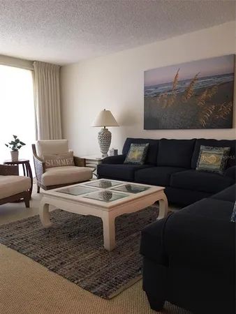 a living room with furniture and a table