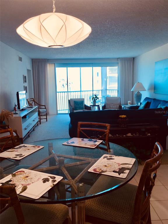 4825 Gulf Of Mexico Drive, Unit 201 Longboat Key, FL 34228 - Photo 6 of 42 a living room with furniture and a table