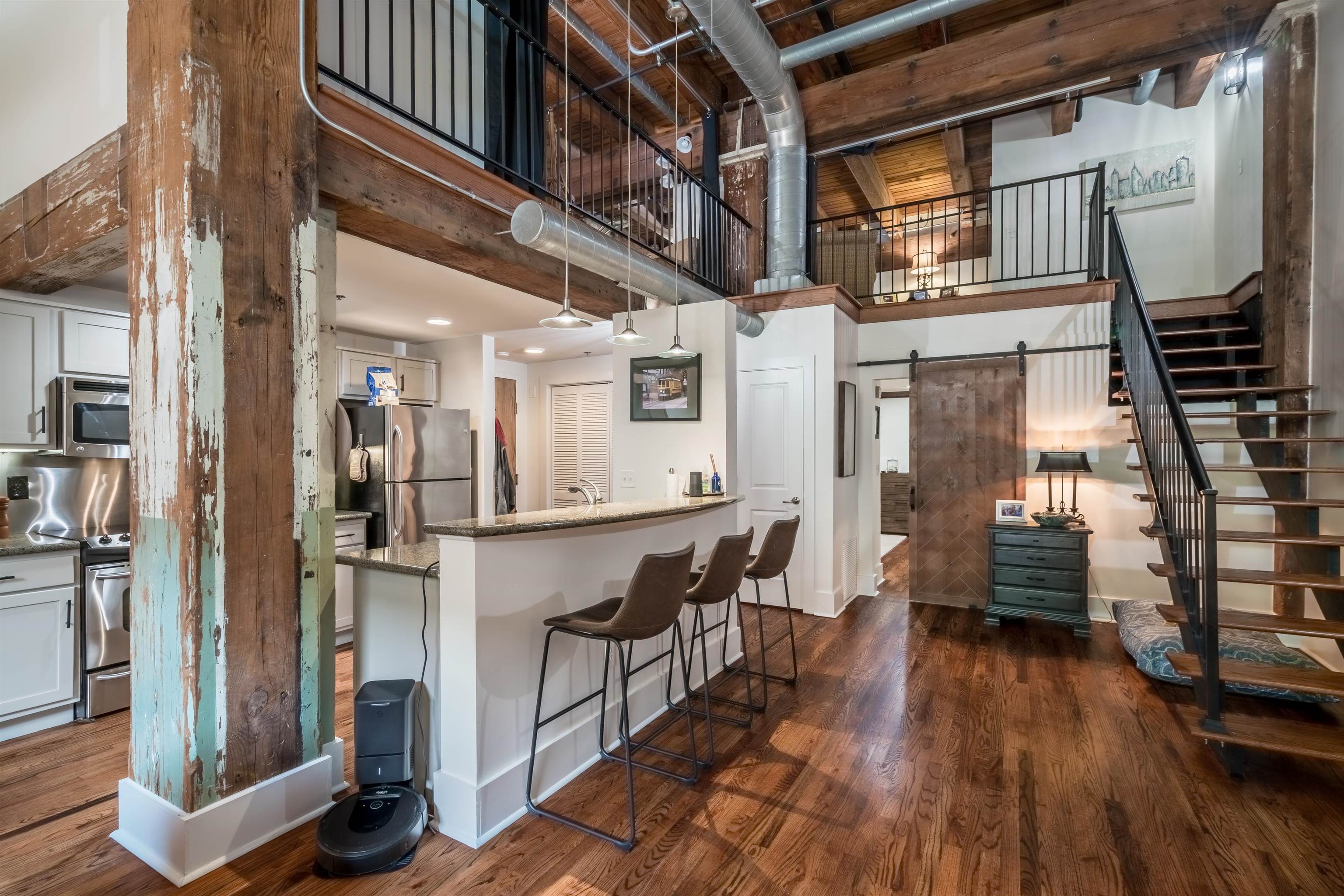 420 South Front Street, Unit 104 Memphis, TN 38103 - Photo 11 of 25 a view of a hallway with wooden floor and staircase