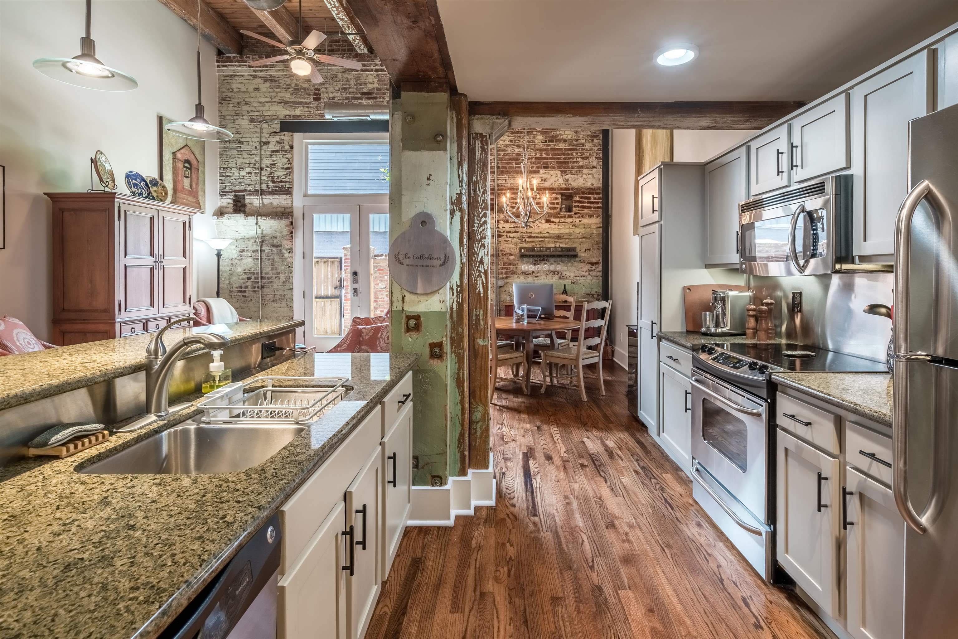 420 South Front Street, Unit 104 Memphis, TN 38103 - Photo 12 of 25 a kitchen with stainless steel appliances granite countertop a sink stove and refrigerator