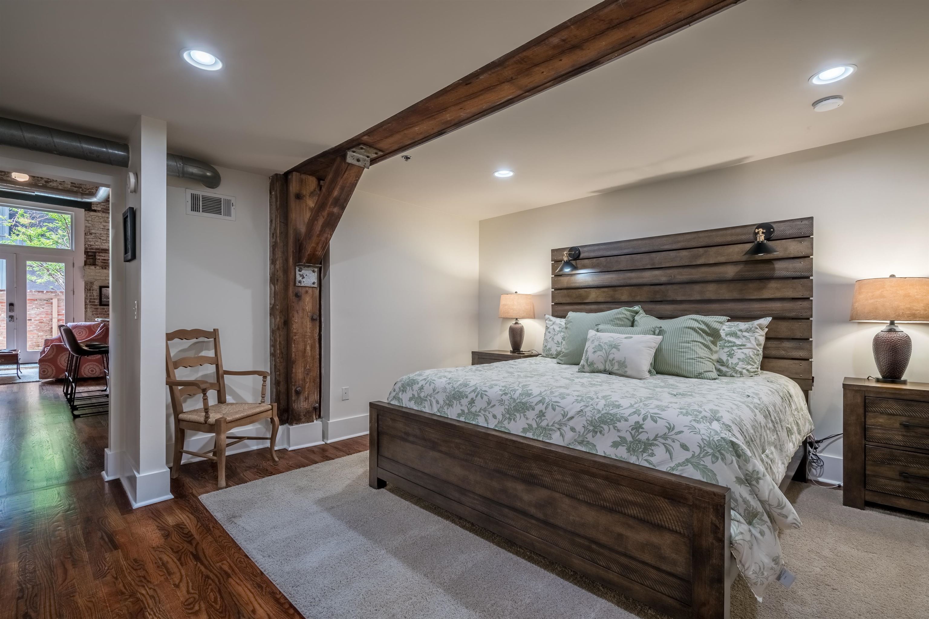 420 South Front Street, Unit 104 Memphis, TN 38103 - Photo 13 of 25 a bedroom with a bed and a mirror