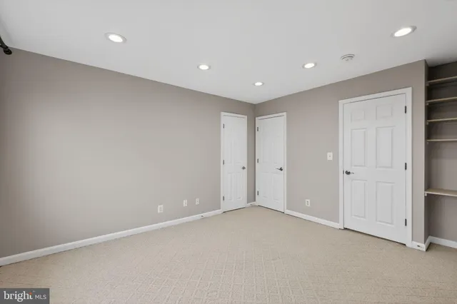 a sign of golf club on a wall under a tree