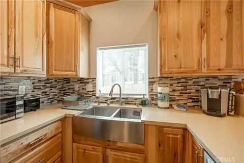 a kitchen with a sink a counter and cabinets