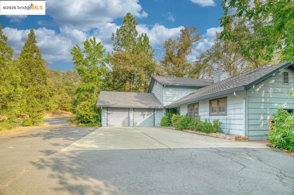 19195 Ferretti Road Groveland, CA 95321 - Photo 2 of 51 View of front of property with driveway, a garage, and a chimney