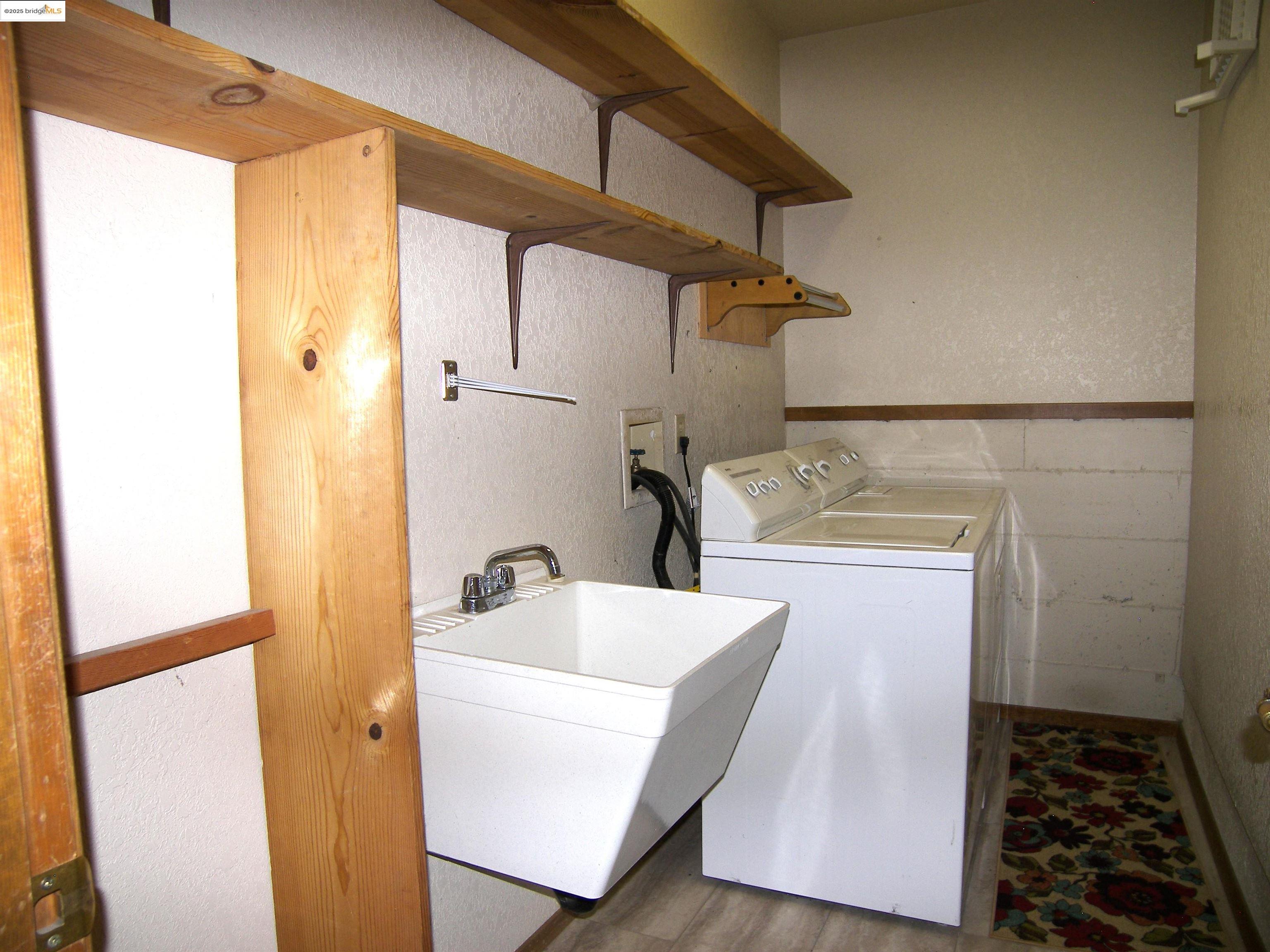 19195 Ferretti Road Groveland, CA 95321 - Photo 26 of 51 Washroom with a textured wall, a wainscoted wall, tile walls, wood finished floors, and separate washer and dryer