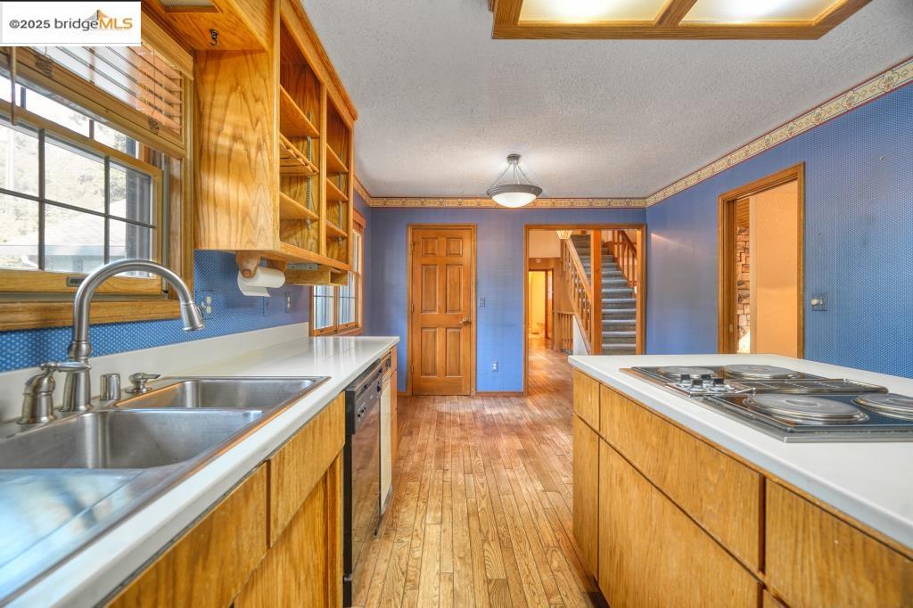 19195 Ferretti Road Groveland, CA 95321 - Photo 7 of 51 a kitchen with stainless steel appliances granite countertop a sink a stove and a wooden cabinets