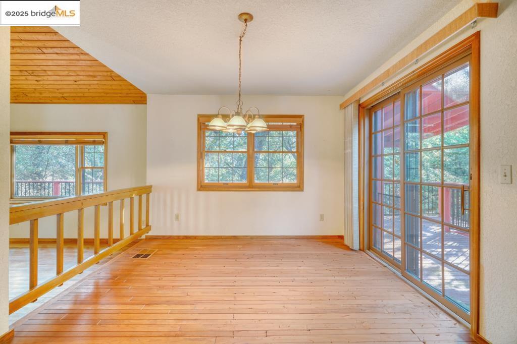 19195 Ferretti Road Groveland, CA 95321 - Photo 8 of 51 a view of an empty room with wooden floor and a window