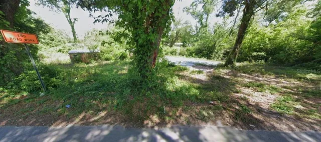 a backyard of a house with lots of green space and chair