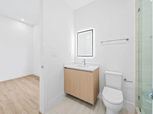 an empty room with wooden floor and a window