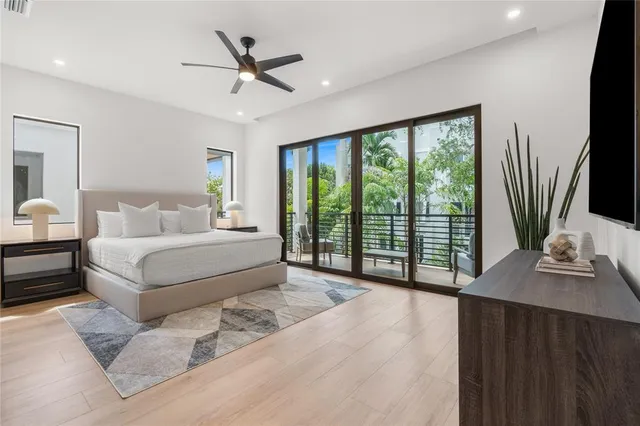 a bedroom with a large bed and a chandelier