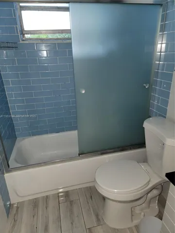 a bathroom with a toilet and bathtub