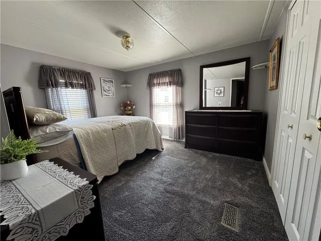 a living room with a bed furniture and a window