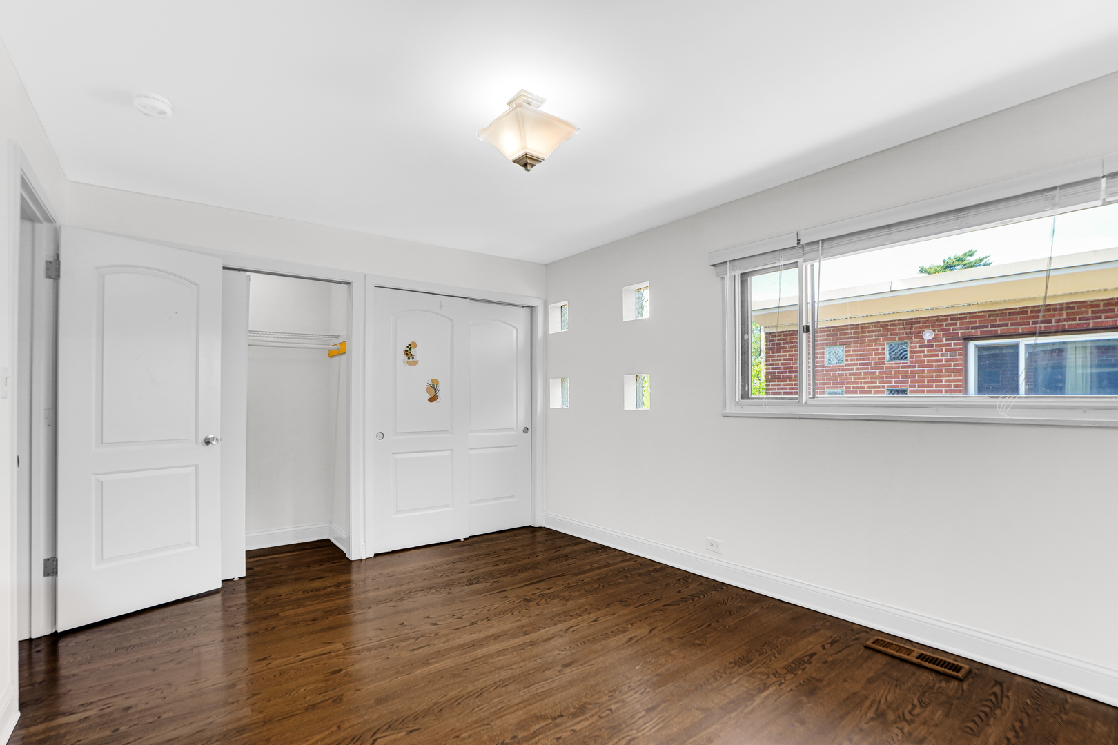 503 Ridge Road, Unit 21 Wilmette, IL 60091 - Photo 11 of 21 a view of an empty room with wooden floor and a window