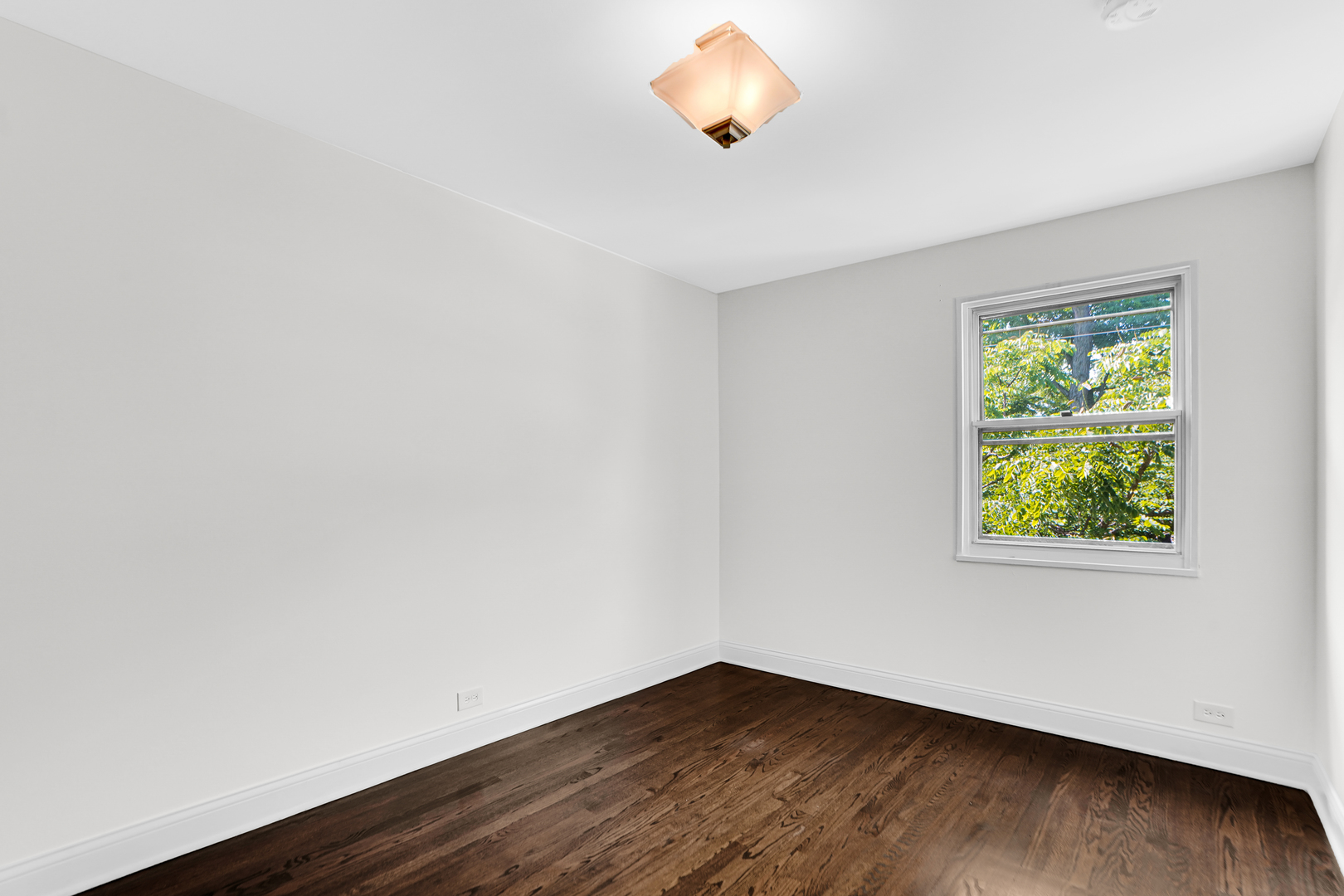 503 Ridge Road, Unit 21 Wilmette, IL 60091 - Photo 12 of 21 an empty room with wooden floor and windows