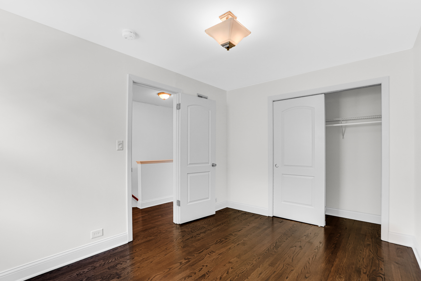 503 Ridge Road, Unit 21 Wilmette, IL 60091 - Photo 13 of 21 an empty room with wooden floor and windows