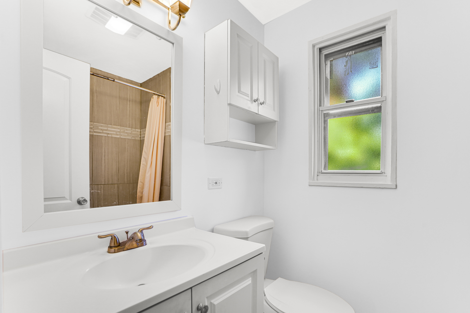 503 Ridge Road, Unit 21 Wilmette, IL 60091 - Photo 16 of 21 a bathroom with a sink a toilet and mirror