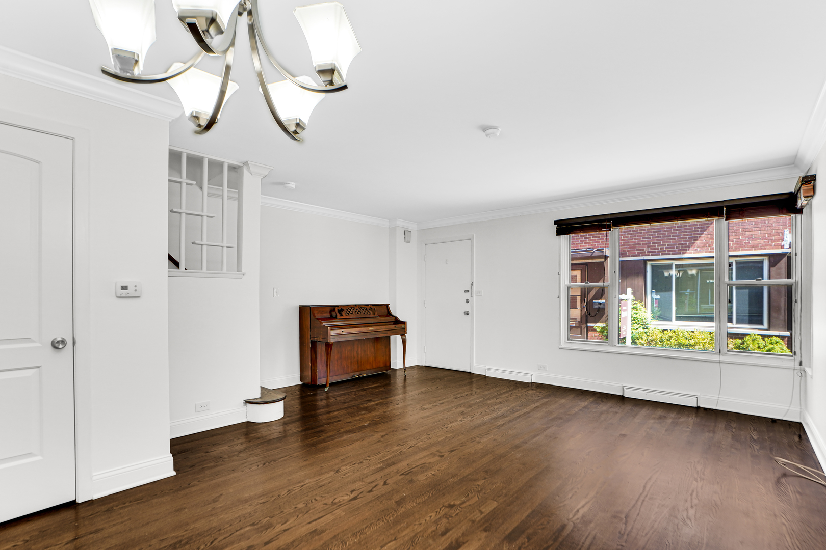 503 Ridge Road, Unit 21 Wilmette, IL 60091 - Photo 19 of 21 a view of an empty room with wooden floor and a window