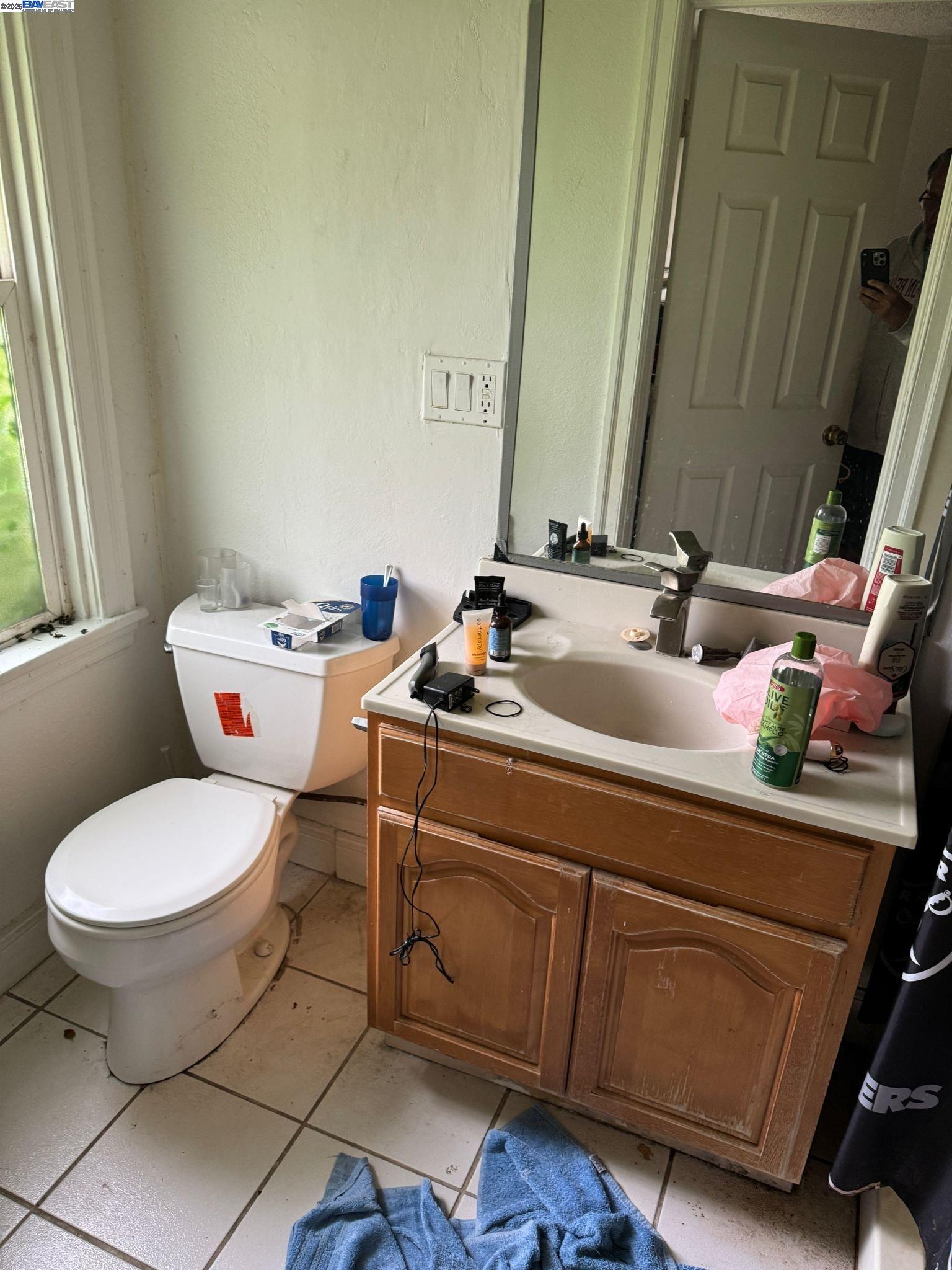 2123 High Street Oakland, CA 94601 - Photo 12 of 14 a bathroom with a sink and a toilet