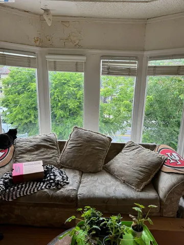 a living room with furniture and a floor to ceiling window
