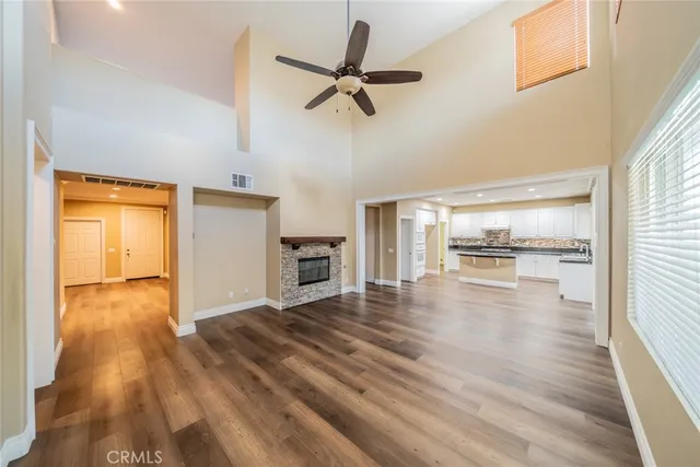 a view of empty room with wooden floor and fireplace