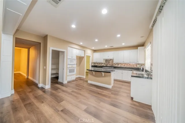 a kitchen with stainless steel appliances granite countertop a stove and a sink