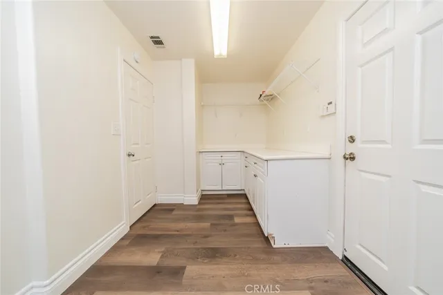 a large kitchen with granite countertop a sink counter top space and stainless steel appliances