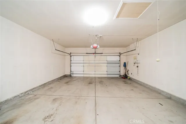 a kitchen with a refrigerator and white cabinets