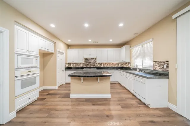 a spacious bathroom with a tub sink and mirror