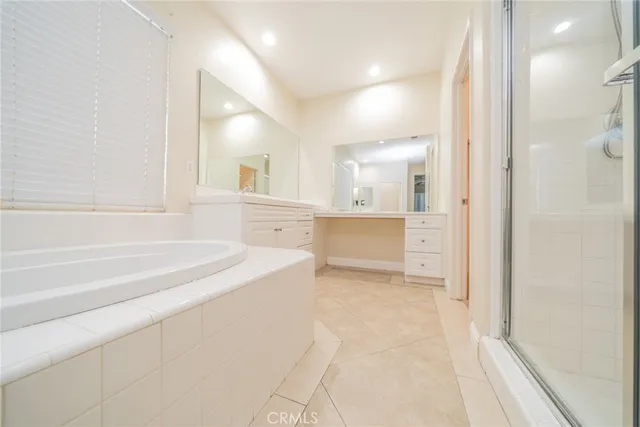 a bathroom with a sink a mirror and a shower