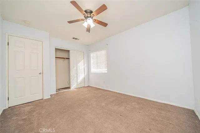 an aerial view of a city with lots of residential buildings ocean and mountain view in back