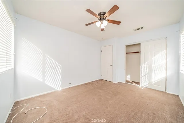 an aerial view of a city with lots of residential buildings ocean and mountain view in back