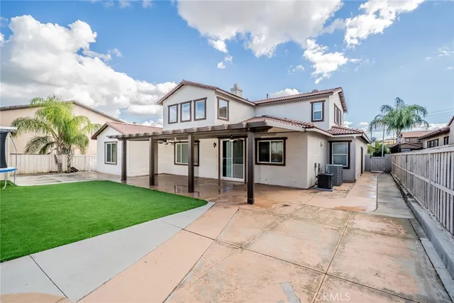 an aerial view of a house with outdoor space patio and lake view in back