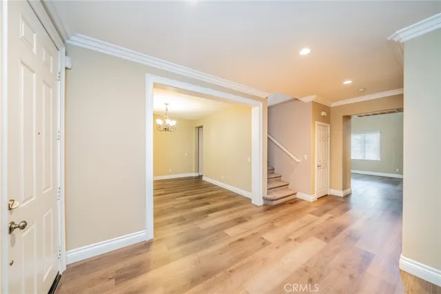 a view of a hallway with wooden floor and bench