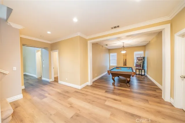 a room with pool table and windows