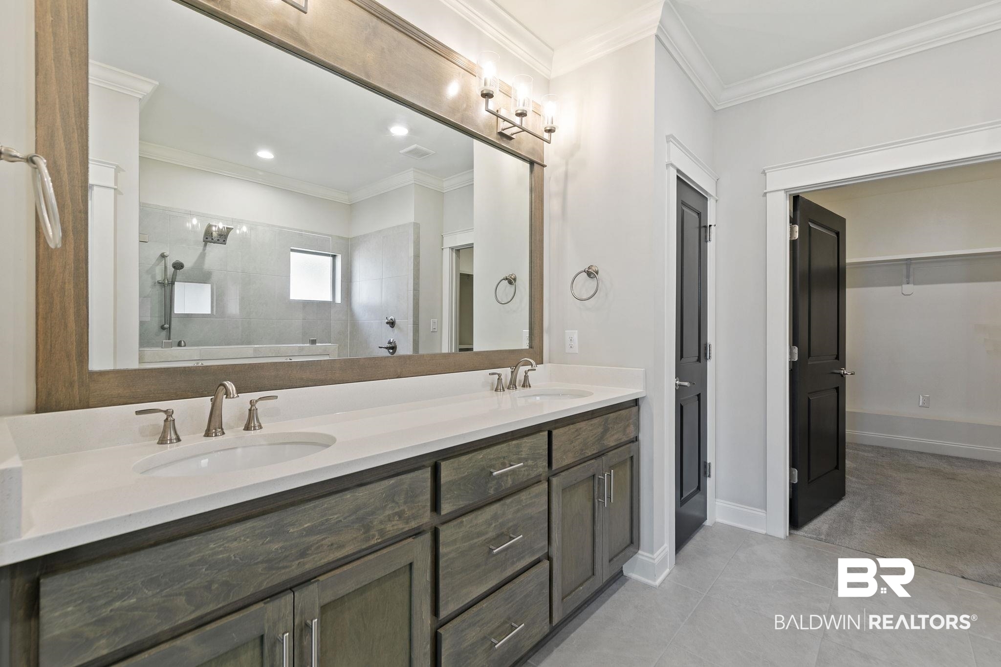 31654 Canopy Loop Daphne, AL 36527 - Photo 33 of 64 Bathroom featuring tiled shower, crown molding, double vanity, a spacious closet, and light tile patterned floors