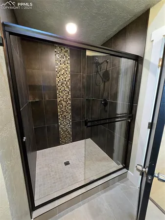 a spacious bathroom with a bathtub and shower