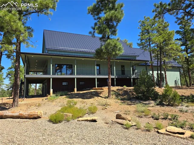 a view of a house with a yard covered in snow