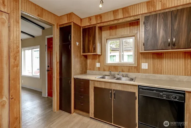 a kitchen with a sink stove and cabinets
