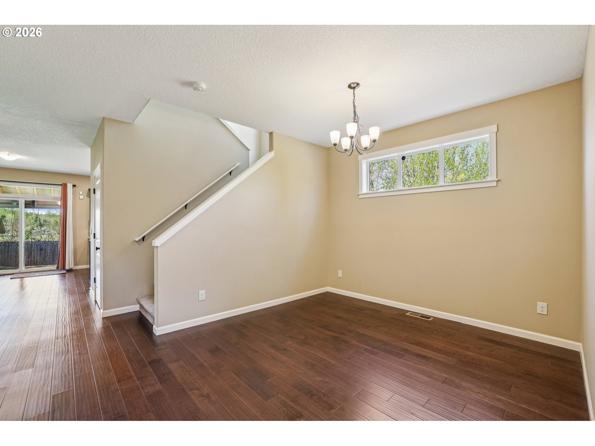 2117 Southeast Cochran Drive Gresham, OR 97080 - Photo 11 of 48 a view of an empty room with wooden floor and a window