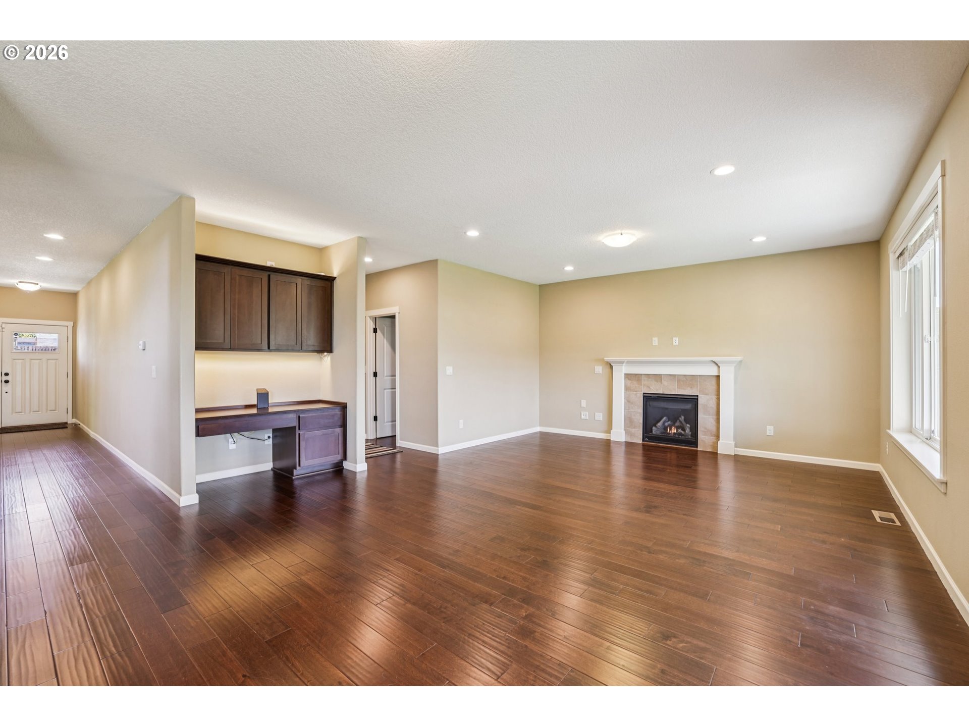 2117 Southeast Cochran Drive Gresham, OR 97080 - Photo 13 of 48 a view of an empty room with wooden floor and a window