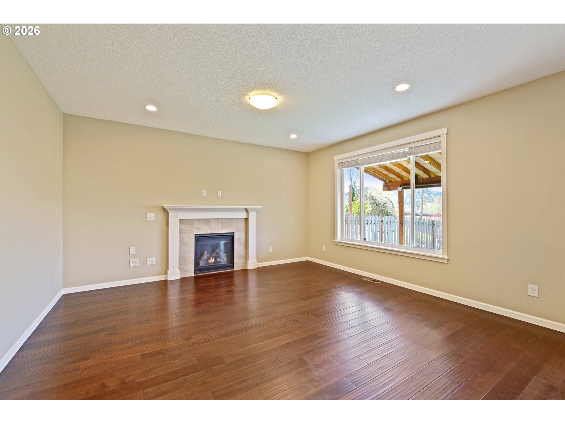2117 Southeast Cochran Drive Gresham, OR 97080 - Photo 14 of 48 a view of an empty room with a window and wooden floor