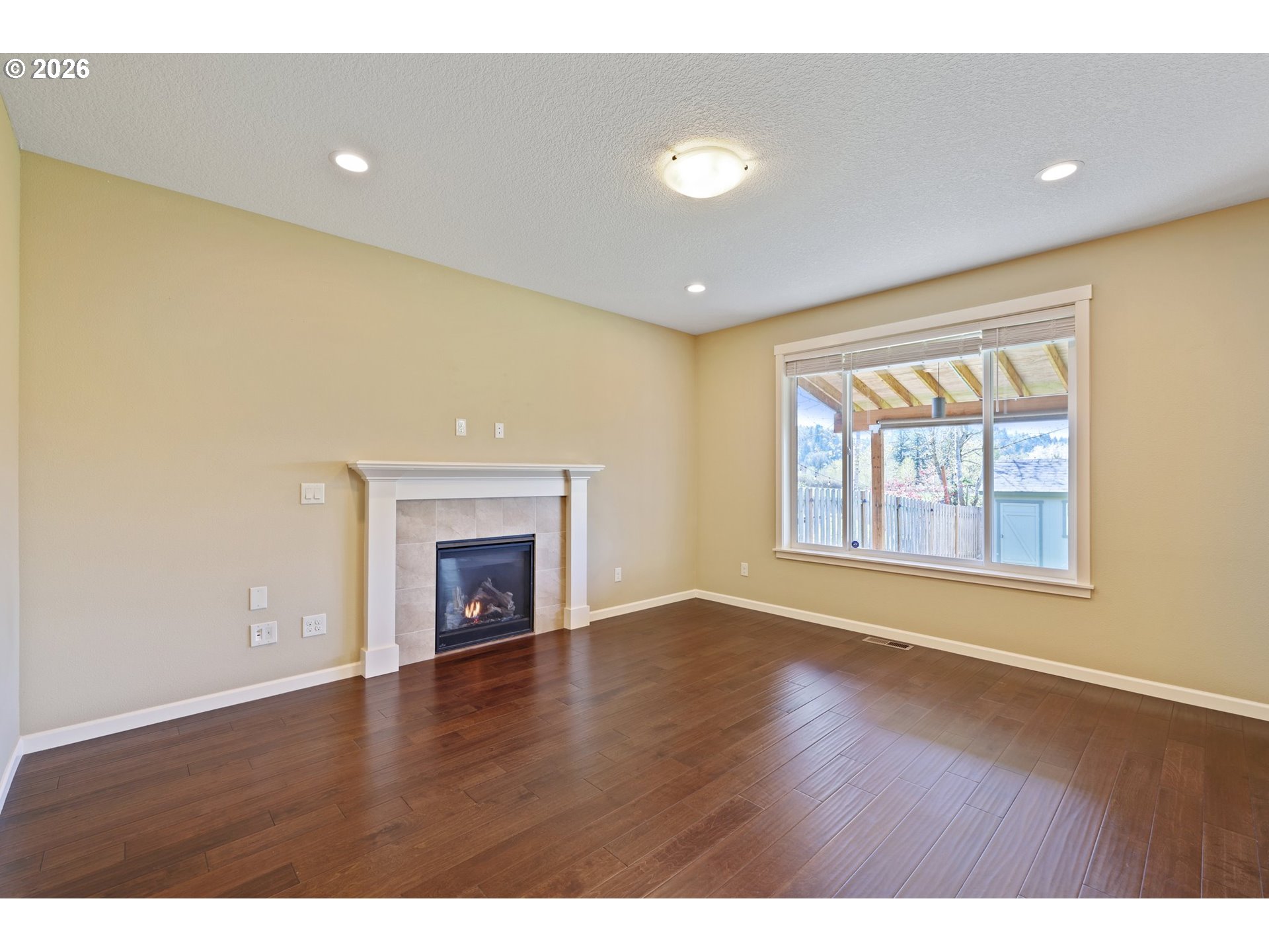 2117 Southeast Cochran Drive Gresham, OR 97080 - Photo 15 of 48 a view of an empty room with a window and fireplace