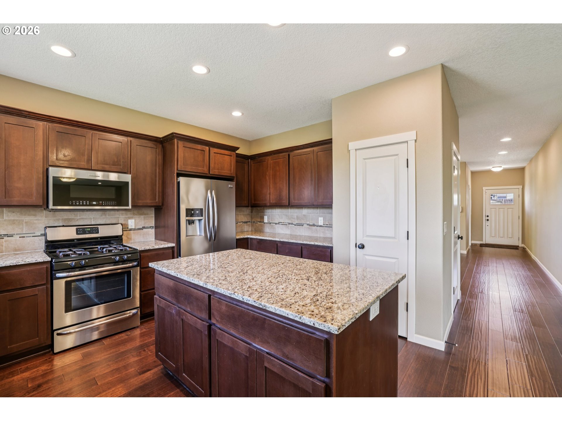 2117 Southeast Cochran Drive Gresham, OR 97080 - Photo 17 of 48 a kitchen with refrigerator cabinets and wooden floor