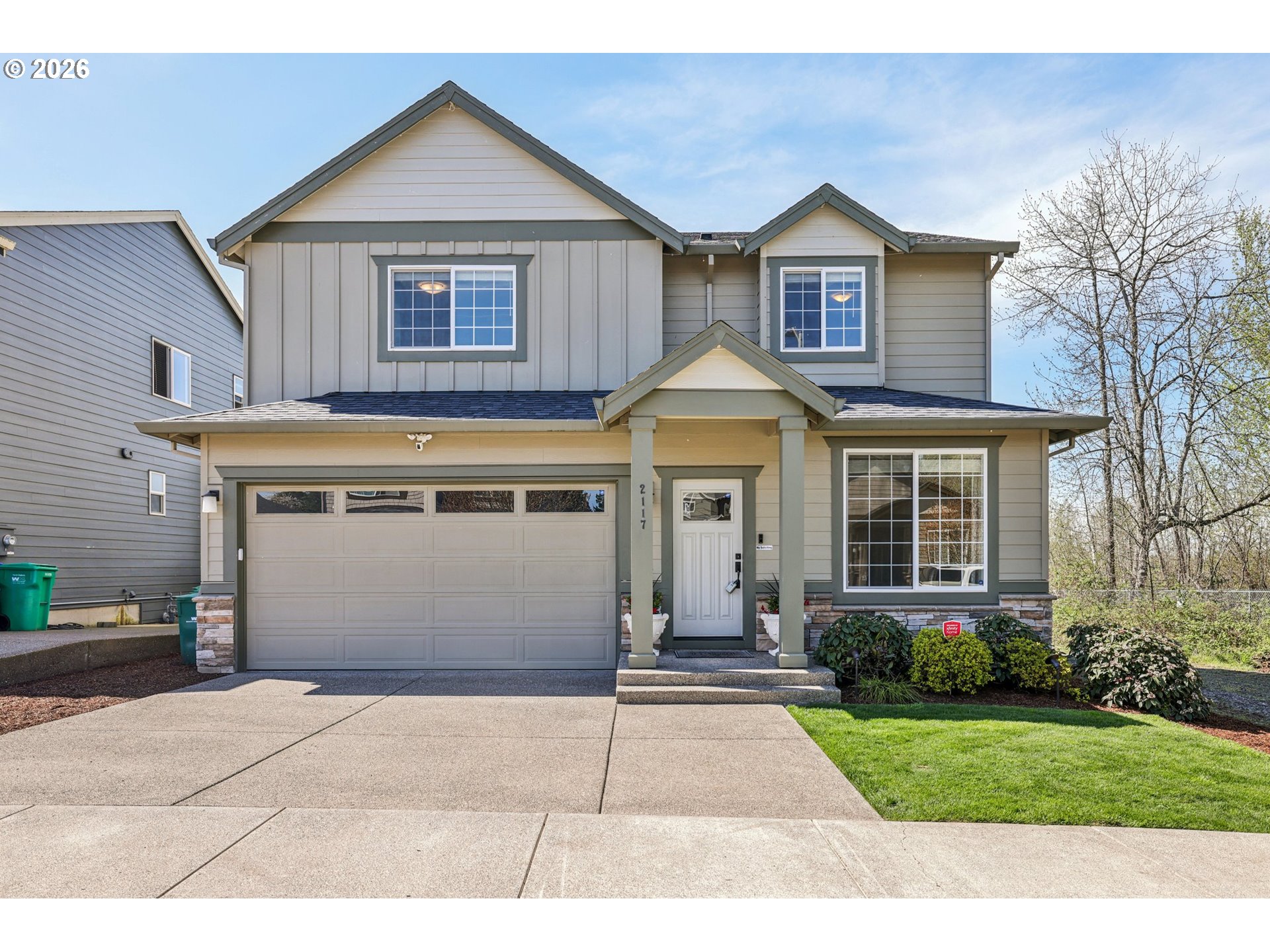 2117 Southeast Cochran Drive Gresham, OR 97080 - Photo 2 of 48 a front view of a house with a yard and garage