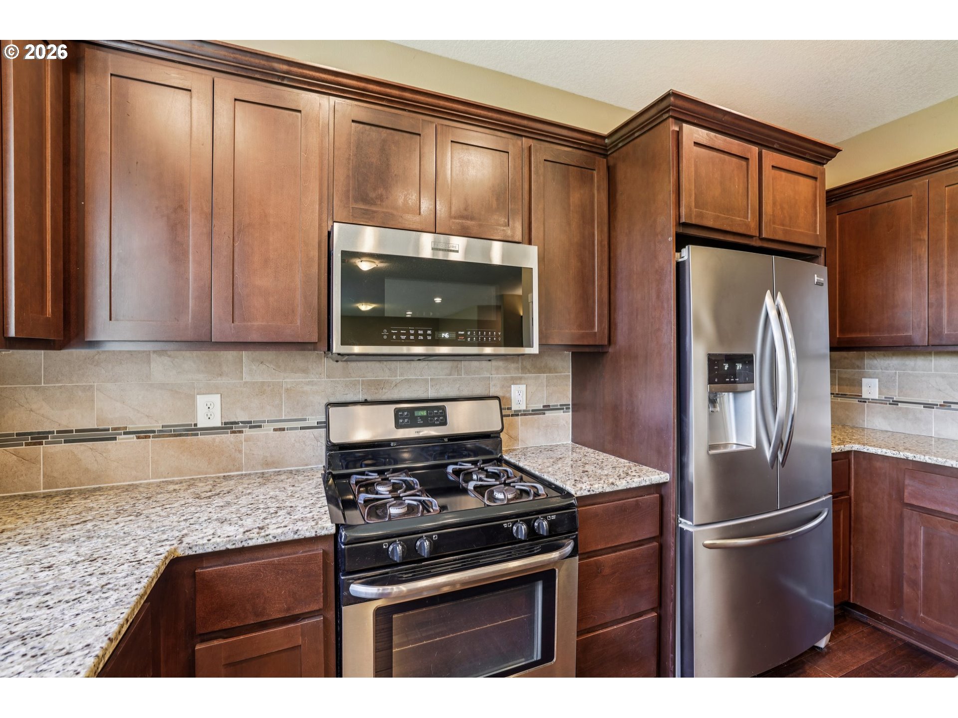 2117 Southeast Cochran Drive Gresham, OR 97080 - Photo 21 of 48 a kitchen with stainless steel appliances granite countertop a refrigerator stove and microwave