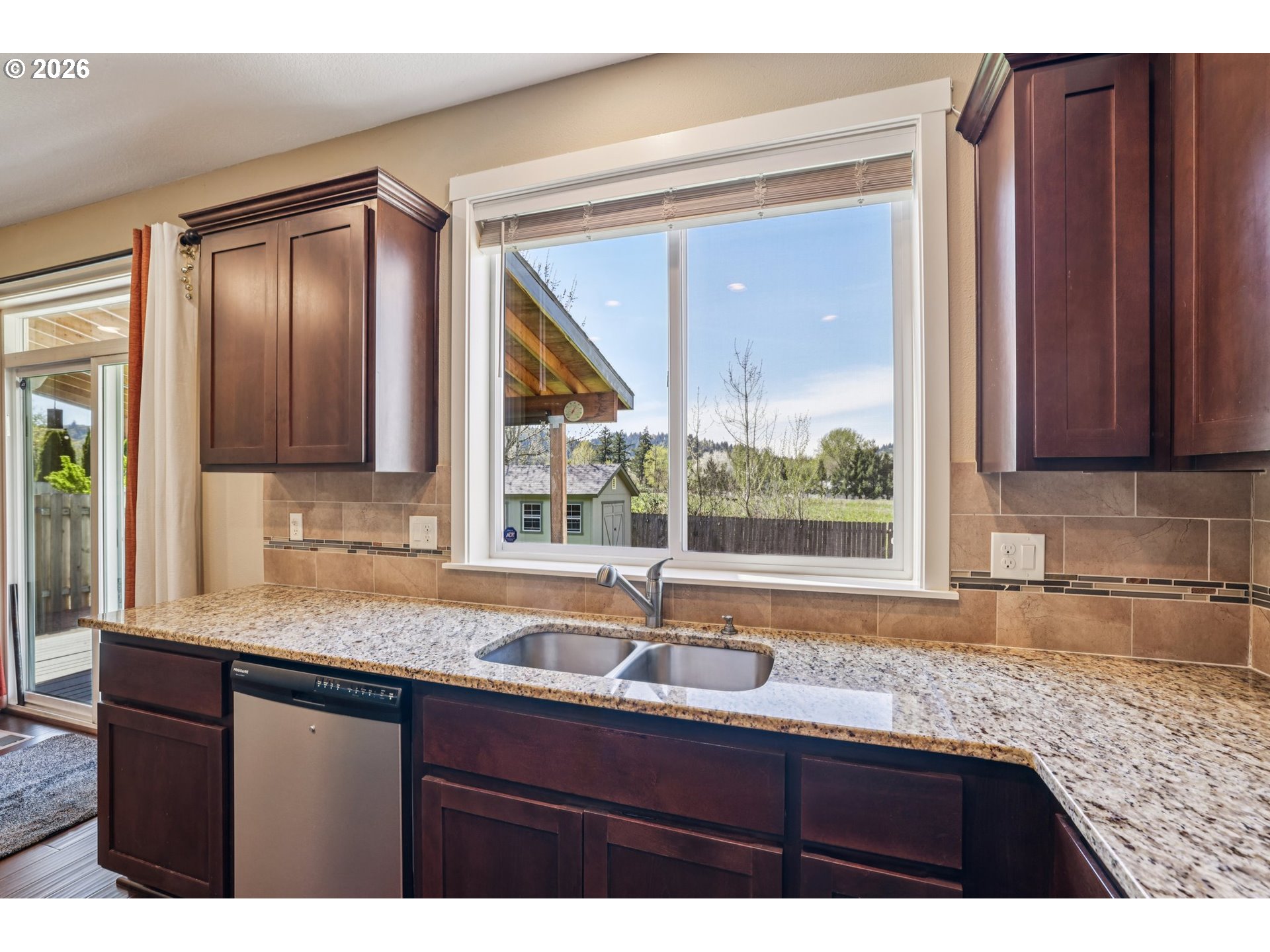 2117 Southeast Cochran Drive Gresham, OR 97080 - Photo 22 of 48 a kitchen with granite countertop a sink and a large window